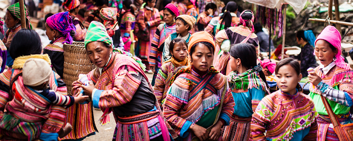 Weekly market days attract the women from different Hmong tribes in the hill country of northeastern Vietnam. The women in this photo are mostly from the Flower Hmong and Black Hmong tribes.